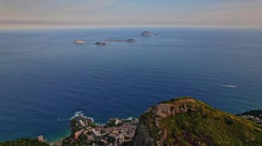 Rio de Janeiro, Brezilya 'da bulunan Dois Irmaos Dağlarının Drone Görüntüleri. Görüntüler okyanustan kıyı şeridine Ipanema Bölgesi ile birlikte Rio şehrine giden yankı hareketleriyle başlıyor..