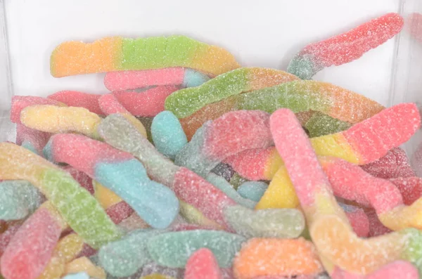 An assortment of sour worm gummy candy.