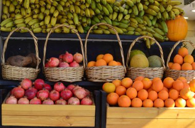 A beautiful display of assortment of seasonal fruits at a local juice shop in downtown area. clipart