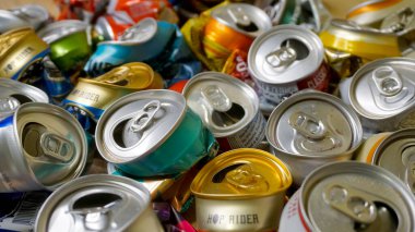 Crumpled colorful tin cans of beer
