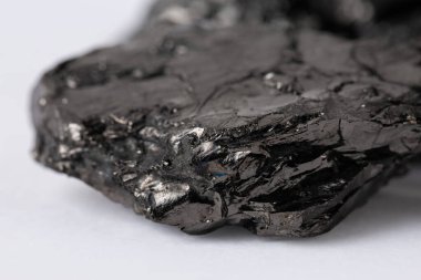 Heap of natural black fossil coal on a white isolated background.
