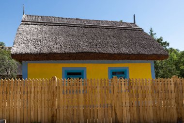 Cute country house with a thatched roof, rustic eco style, ethnic.