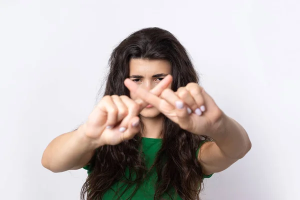 stock image Portrait of a serious young woman showing stop gesture with her palm over white background