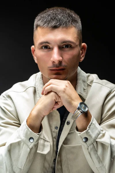 stock image Young successful stylish man. Classical portrait of a businessman dressed in a jacket with a watch on his hand.