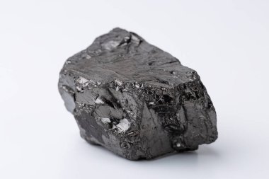 Natural black fossil coal on a white isolated background.