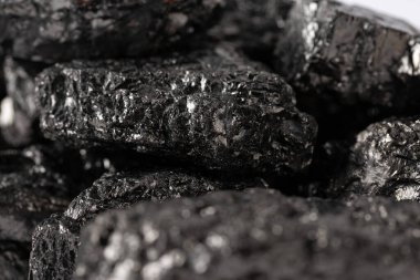 Heap of natural black fossil coal on a white isolated background.