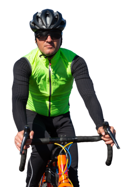 Cyclist riding bicycle on road against clear sky