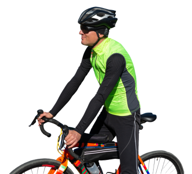 Cyclist riding bicycle on road against clear sky