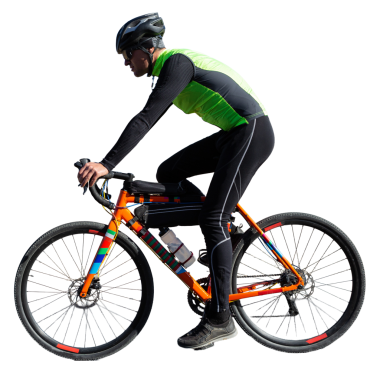 Cyclist riding bicycle on road against clear sky