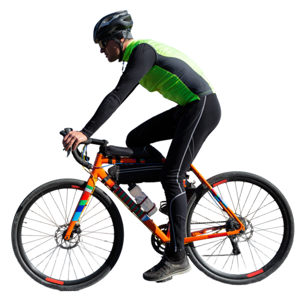 Cyclist riding bicycle on road against clear sky