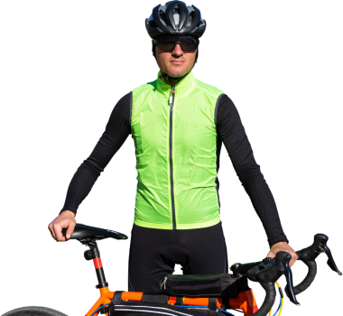 Cyclist riding bicycle on road against clear sky. A man in an outfit stands with a bicycle on an autumn sunny day.