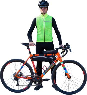 A man in clothes stands with a bicycle on an autumn sunny day. Cyclist in an urban environment.