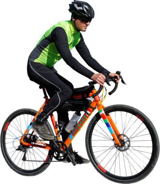 Cyclist riding bicycle on road against clear sky