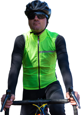 A man in clothes stands with a bicycle on an autumn sunny day. Cyclist in an urban environment.