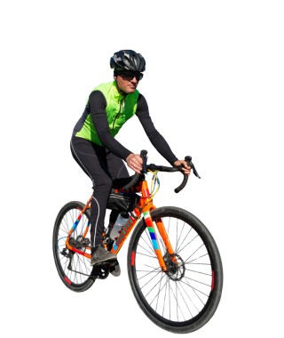 Cyclist riding bicycle on road against clear sky