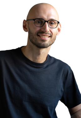 Young successful stylish man with a clean-shaven head wearing glasses. Portrait of a businessman sitting in a chair.