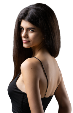Classic studio portrait of a young brunette dressed in a black top, who is sitting on a chair against a black background.