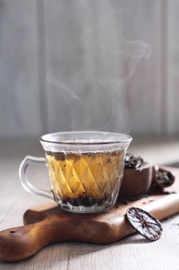 black and white cups with cup of hot coffee, tea and fresh herbs. selective focus.