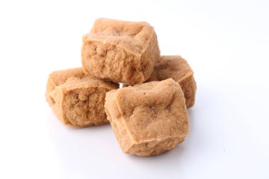 a pile of dried ginger sugar cubes on white background