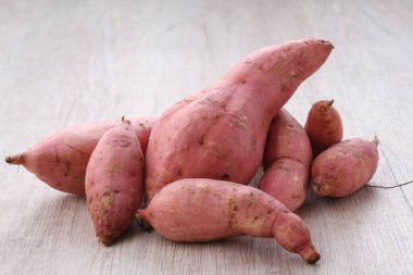 fresh raw red sweet potato on wooden background