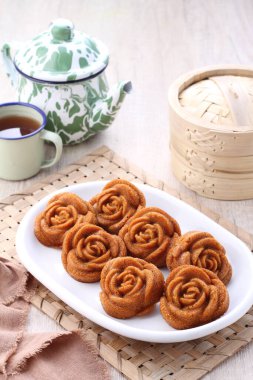 homemade cookies with jam and cup of tea on a plate