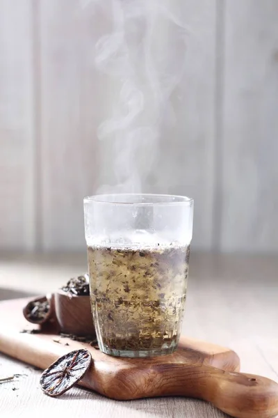 hot coffee with ice cream and cinnamon on a wooden background.