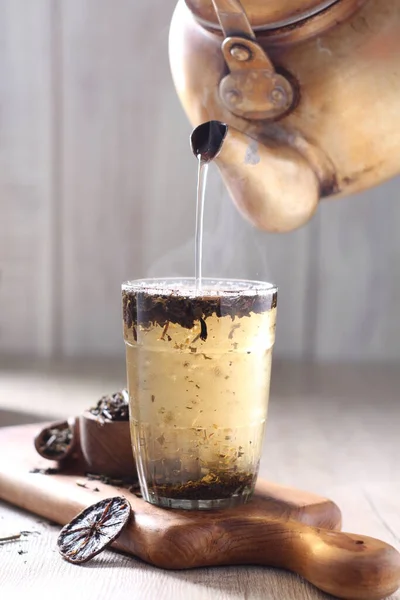 iced coffee with cinnamon and ice cream on wooden table