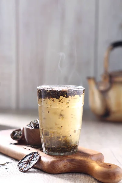 iced coffee with cinnamon and anise on wooden background