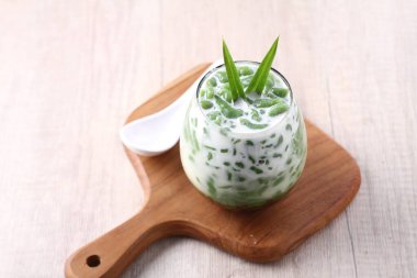 fresh green smoothie with mint and chia seeds on wooden background