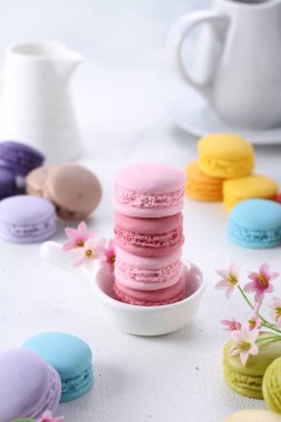 pink macaroons with white and yellow macarons on a light background. selective focus.