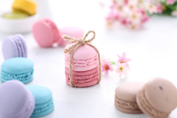macaroons and pink macarons on white background