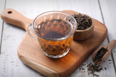 cup of tea and fresh mint on wooden background