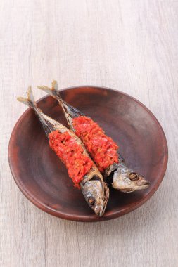 grilled fish with spices and vegetables on a plate
