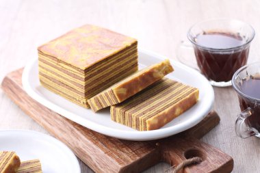 a stack of delicious pancakes with a slice of tea on a wooden board