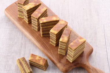 a vertical shot of a stack of chocolate bars on a white background