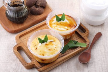 homemade hummus with cream sauce and cheese on wooden background