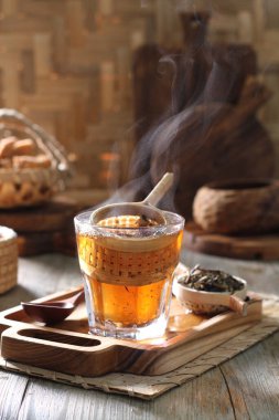Tea is an aromatic beverage prepared by pouring hot or boiling water over cured or fresh leaves of Camellia sinensis, an evergreen shrub native to East Asia which probably originated in the borderlands of southwestern China and northern Myanmar.