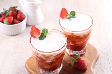 delicious strawberry smoothie with fresh berries on wooden table