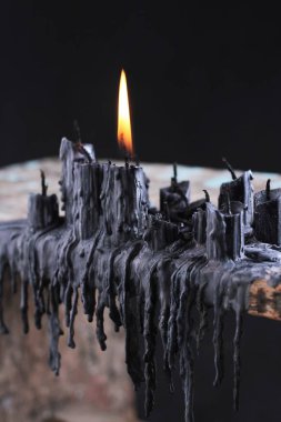 black candle on black background