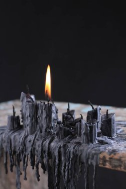 black candle on black background