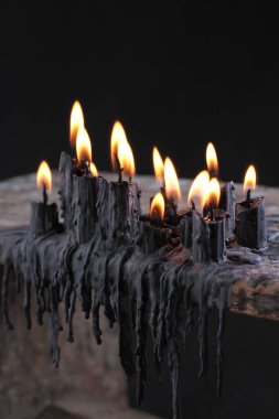 black candle on black background