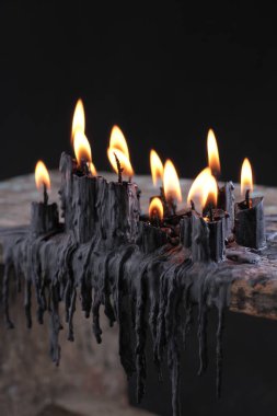 black candle on black background
