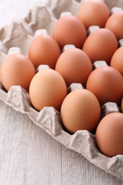 raw chicken eggs in a bright background