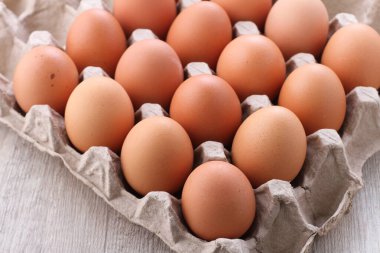 raw chicken eggs in a bright background