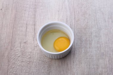 bowl of tasty homemade mayonnaise sauce on wooden background