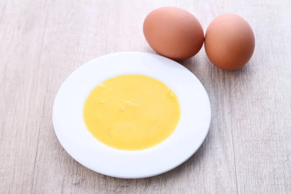 egg yolk with boiled eggs on white background