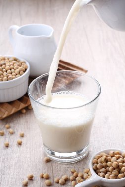 soy milk in glass jar on wooden table