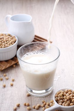 soy milk and soybean seed on white background