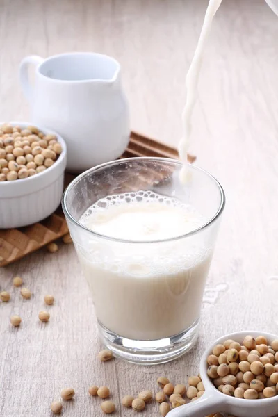 soy milk and soybean seed on white background