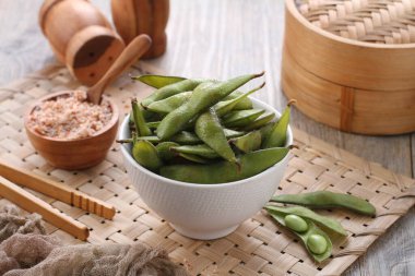Edamame is Japanese dish and prepared of immature soybeans in the pod. The pods are boiled or steamed and may be served with salt or other condiments. Nowadays it became to be so popular in the world